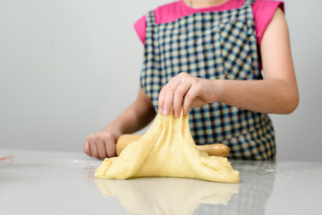 Close up kid hands prepare dough.