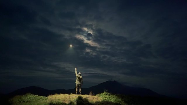 The UFO flight above the male in a night mountain