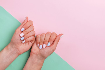 Woman's hands with beautiful salon manicure in light colors