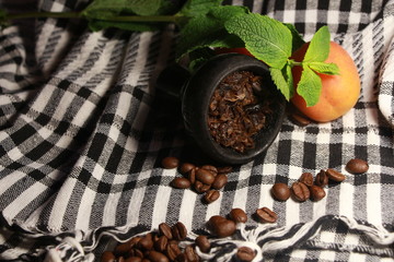 bowl with tobacco for hookah. fruits and berries on a black background. smoke hookah