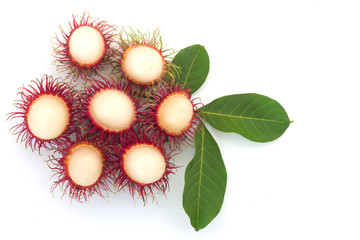 Fresh Rambutan with green leaves isolated on white background