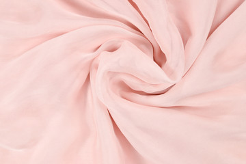 Soft smooth pink silk fabric background. Fabric texture.