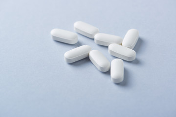 Lysine tablets. Concept for a healthy dietary supplementation. Nervous System Support. Bright background. Close up. Copy space.  