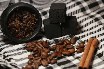 bowl with tobacco for hookah. fruits on a black background