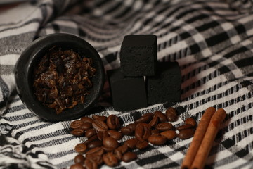 bowl with tobacco for hookah. berries on a black background