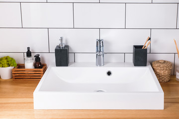 Bathroom sink on wooden countertop close-up