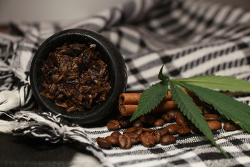 bowl with tobacco for hookah. berries on a black background