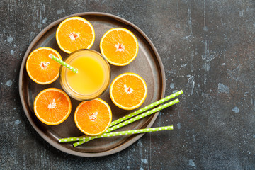 Fresh oranges and glass of juice