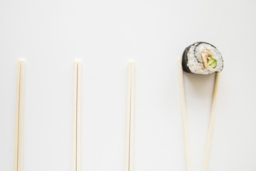 Top view sushi roll with chopsticks