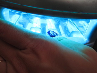 hand pushing a button on touch screen interface