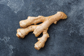 Fresh ginger root on grey background. Copy space.