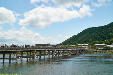 Fototapeta na wymiar Katsura river,Arashiyama,Kyoto,Japan - July 7,2019 : Bridge over Katsura river at Arashiyama with some people