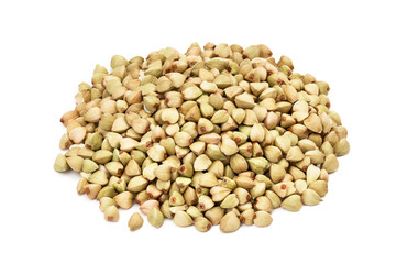 Pile or heap of green buckwheat seeds seen obliquely from above and isolated on white background