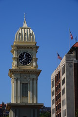 Fototapeta na wymiar Beautiful clock tower scales over the city