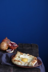 Khachapuri Ajarian on blue background