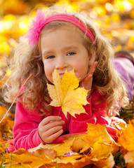 Naklejka na ściany i meble Happy girl in autumn park