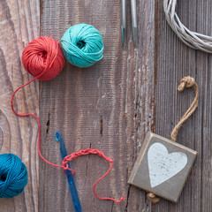 Crochet, top view on yarn balls on wood