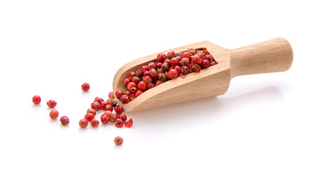 Red peppercorn in wood scoop isolated on white background