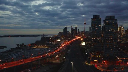 Aerial of traffic congestion near downtown Toronto at night. DOLLY LEFT