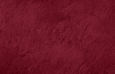 Close up of abstract dark red stone texture  with high resolution. Autumn winter 2020 color trend.