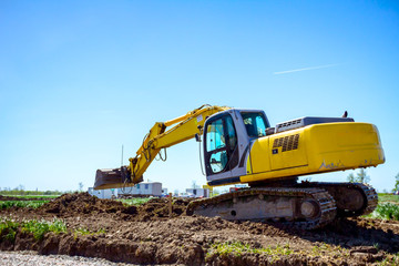 Fototapeta na wymiar Excavator is digging on building site