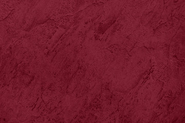 Close up of abstract dark red stone texture  with high resolution. Autumn winter 2020 color trend.