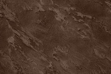 Close up of abstract dark brown stone texture with high resolution.