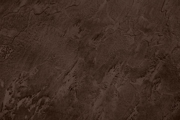Close up of abstract dark brown stone texture with high resolution.