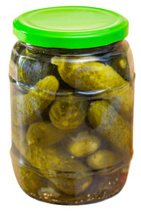 Pickled cucumbers with spices in glass jar