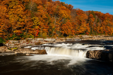 Fototapeta na wymiar Ohiopyle Falls - Long Exposure Waterfall in Waterfall in Peak Autumn / Fall Season - Ohiopyle State Park, Pennsylvania