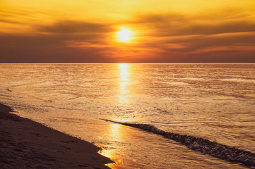 Sunset - sun reflecting in sea/ ocean, shore