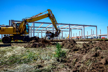 Excavator is digging on building site