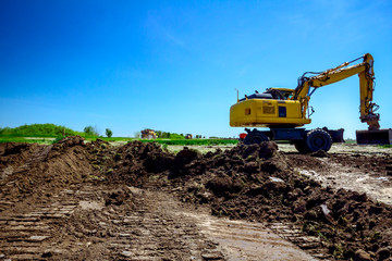 Excavator is digging on building site