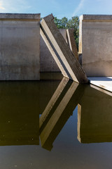 Waterloopbos, The Netherlands, August 25, 2019: the concrete national monument, reflecting in the surrounding water, former experimental hydraulic facility of Delft Laboratory