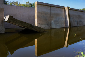 Waterloopbos, The Netherlands, August 25, 2019: the concrete national monument, reflecting in the surrounding water, former experimental hydraulic facility of Delft Laboratory