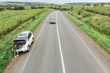 woman stuck with broken car in the middle of nowhere.