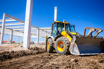 Low view on front excavator's work tool, blade