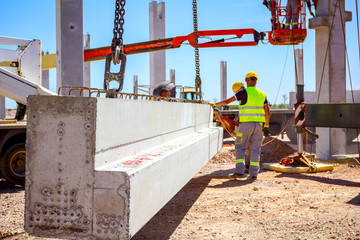 Worker is using grinder for cutting cement pillar excess of material to correct measure