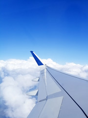 Beautiful view from the window of an airplane. View from the aircraft's illuminator. Flying above the clouds. We are flying on vacation. Fear of flying..