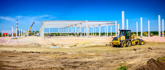 Panoramic view on leveling machine, grader, until is leveling ground at building site