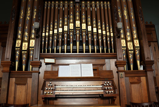 Closeup of an old pipe organ in a church.