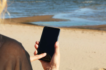 Smartphone in the hand of a business woman