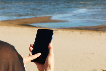 Smartphone in the hand of a business woman