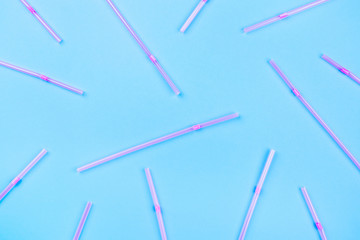 Pink cocktail straws on a color background.