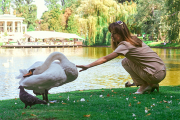 woman by the lake with a swan
