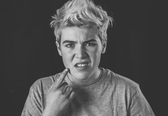 Portrait of a young teenager looking skeptical and displease with something that he dislike