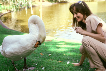 woman by the lake with a swan