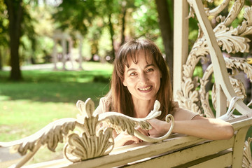 portrait of a woman on a park bench