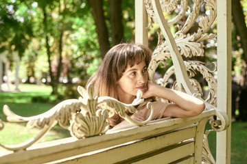portrait of a woman on a park bench