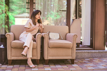woman on a sofa near a restaurant